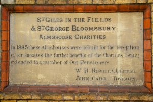 Commemorative plaque of rebuilt St Giles Almshouses - 1885